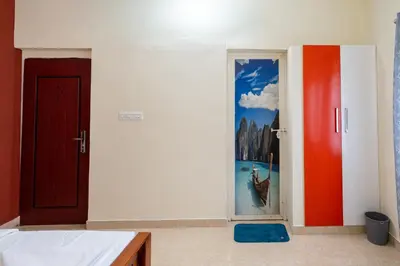 a room with a door with a painting on it at CLUB 4 Homestay in Nedumbassery