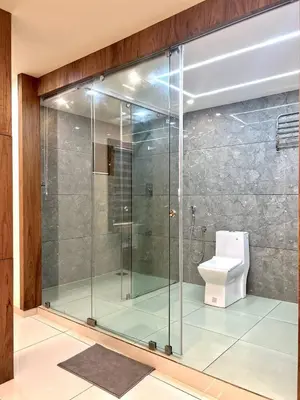 a glass shower in a bathroom with a toilet at Vilstay Premium- Fathima 2BHK in Kottakkal