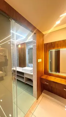 a bathroom with a glass shower and a sink at Vilstay Premium- Fathima 2BHK in Kottakkal