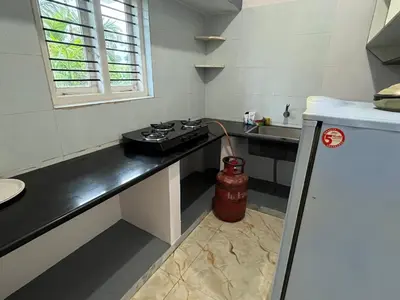 a kitchen with a sink and a fire hydrant at S R Retreat in Dodbelvangala