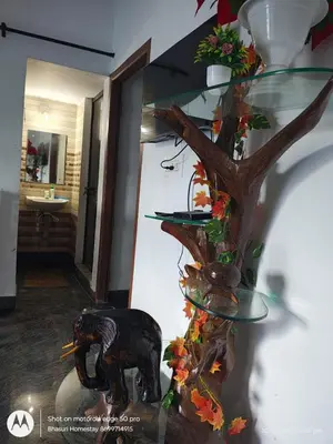 a glass stand with an elephant and a tree at Bhasuri AC Room 1 in Agali