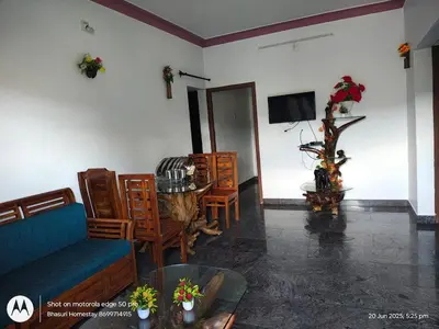 a living room with a couch and a table at Bhasuri NON-AC Villa with Kitchen in Agali
