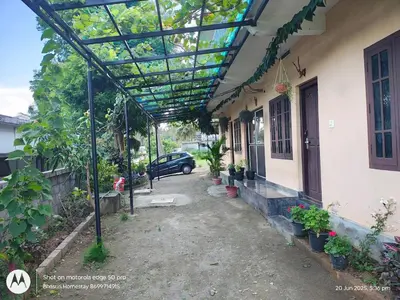 a pergola on the side of a house at Bhasuri NON-AC Villa with Kitchen in Agali