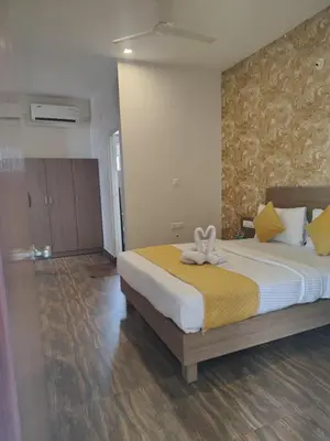 a bedroom with a large bed with a bow on it at North star in Mysore