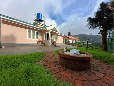 a house with a brick circle in the yard at Meadows Mountain Villa in Ooty