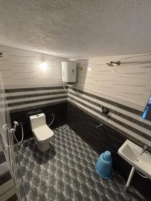 a bathroom with a toilet and a sink at Coorg Sunrise Cottage Homestay in Kushālnagar