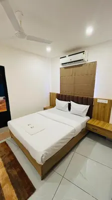 a bedroom with a large bed in a room at LF Apartment in Kozhikode