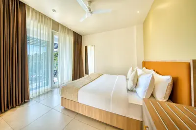 a bedroom with a large bed and a large window at MYSA Sky Suites, Lakkidi in Vythiri