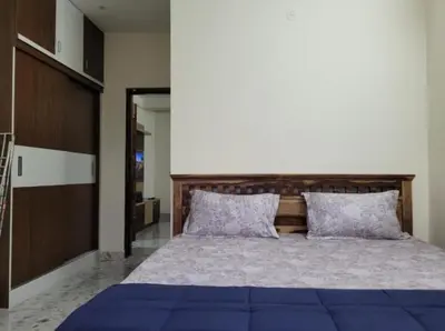 a bedroom with a large bed with purple pillows at Sree Guruvayur Inn in Guruvāyūr