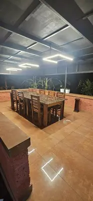 a dining room with a table and chairs at Romanzia Village Homestay in Mānantoddy
