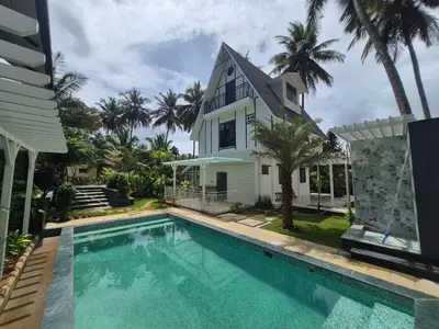 a house with a swimming pool in front of a house at The Gable in Seringapatam