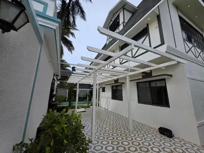 a white house with a white pergola at The Gable in Seringapatam
