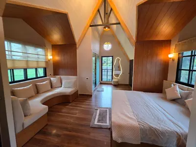 a large bedroom with a large bed and windows at The Gable in Seringapatam