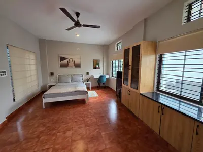 a bedroom with a bed and a ceiling fan at The Gable in Seringapatam