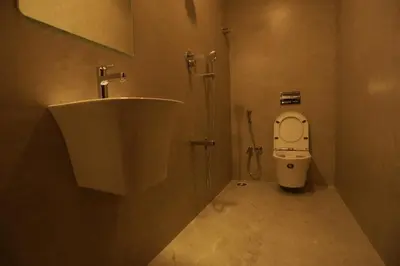 a bathroom with a sink and a toilet at Arthana Residency Hotel