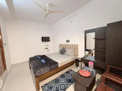 a bedroom with a bed and a ceiling fan at 2 Bedrooms AC Homestay call 8O882-37972 in Mysore