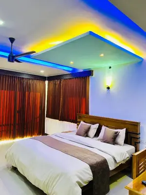 a bedroom with a large bed with a colorful ceiling at Private Pool Villa by Green View in Vythiri