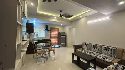 a living room and kitchen with a couch and a table at Divin Le Divine 150 meter to temple in Guruvāyūr