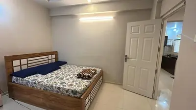 a small bedroom with a bed and a door at Divin Le Divine 150 meter to temple in Guruvāyūr