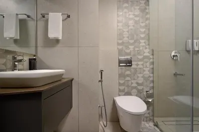 a bathroom with a sink and a toilet and a shower at CASTELO Inn in Nedumbassery