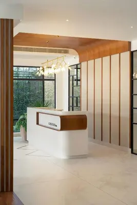 a lobby with a reception desk in a building at CASTELO Inn in Nedumbassery