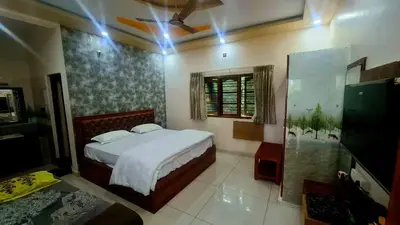 a bedroom with a bed and a ceiling fan at NesaraVana - Ecostay in Hārohalli