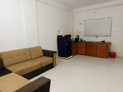 a living room with a couch and a tv at Divin Kalpaka 150 meter to temple in Guruvāyūr