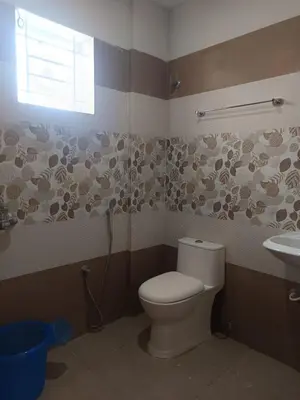 a bathroom with a toilet and a sink at Divin Kalpaka 150 meter to temple in Guruvāyūr