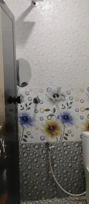 a bathroom with a painting of flowers on the ceiling at Misty plaza in Vattavada