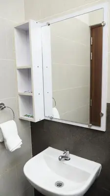 a bathroom with a sink and a mirror at DEJAVU TRANZS - Trishul in Coimbatore