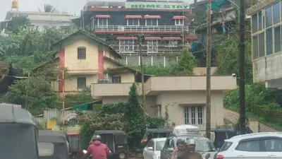 a busy city street with cars and a building at Coorg veena villa in Madikeri