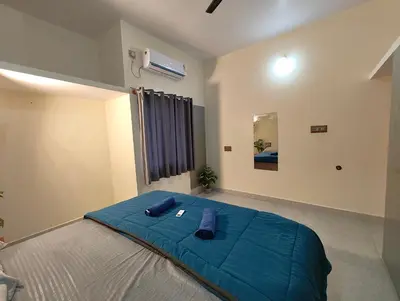 a bedroom with a large blue bed in a room at Galaxy Homestay Mysore 4bhk - Family friendly in Mysore
