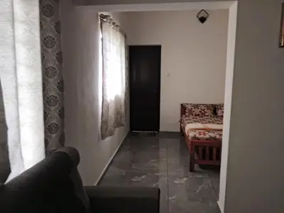 a living room with a couch and a window at Johnnys Destination in Angamali