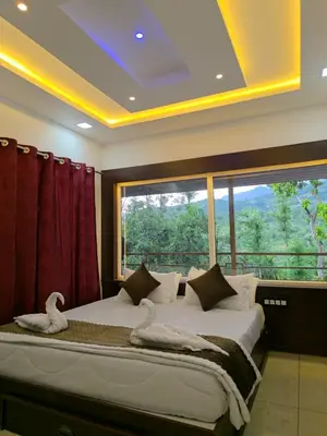 a bedroom with a large bed with swans on it at wild casa in Kanthalloor