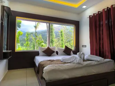 a bedroom with a bed with a large window at wild casa in Kanthalloor