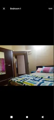a bedroom with a bed with a colorful comforter at PARK VIEW In MYSORE CITY in Mysore