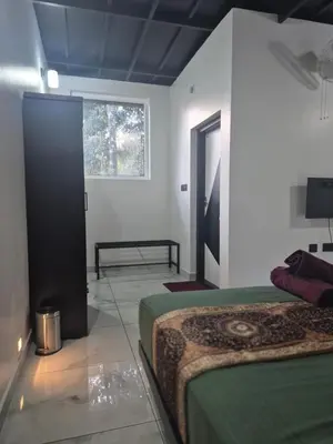 a bedroom with a bed and a window at Cabana banasura Wayanad 2bhk in Padinjarathara