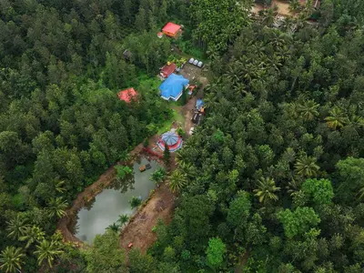 an aerial view of a house in the middle of a forest at Rising Surya Homestay in Kushālnagar