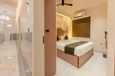 a bedroom with a bed and a tv in a room at Legacy Inn, Mysore in Mysore