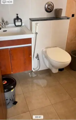 a bathroom with a toilet and a sink at Aarav Stays in Mysore