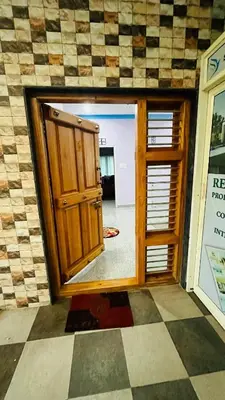 a room with a door open to a room with a floor at Mysore Stopover in Mysore