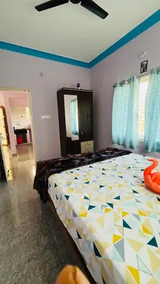 a bedroom with a large bed in a room at Mysore Stopover in Mysore