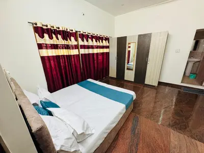 a bedroom with a bed and a red curtain at LUXE Penthouse 4BHK with Swimming pool in Mysore