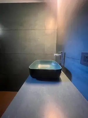 a bathroom with a black tub sitting on a counter at Farmscape Retreat in Gonikoppal