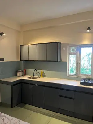 an empty kitchen with a sink and a window at Farmscape Retreat in Gonikoppal