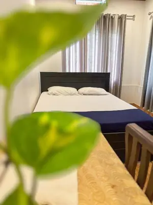 a bedroom with a bed and a table with a bed sidx sidx sidx at kadalundi Heritage in Vallikunnu