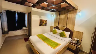 a bedroom with a large bed in a room at VR Residency in Ooty