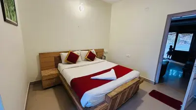 a bedroom with a bed in a room with a window at VR Residency in Ooty