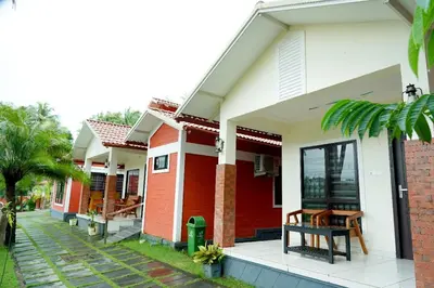 a row of houses with red and white at Daya Village in Tirūrangādi