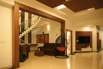 a living room with a chair and a couch at The Glen By Bloobuck in Ambalavayal